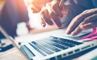 Person typing at desk setup